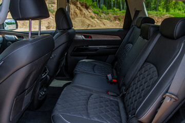 Modern SUV car inside. Leather black back passenger seats in modern luxury car. Comfortable leather seats.