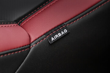 Close up view of airbag label on the side of a car seat. Airbag safety system symbol on the car...