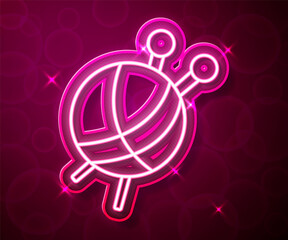 Glowing neon line Yarn ball with knitting needles icon isolated on red background. Label for hand made, knitting or tailor shop. Vector