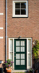 Fototapeta na wymiar Beautiful entrance green door in the heart of Haarlem city, the Netherlands