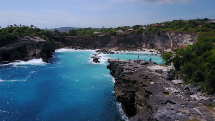 drone view ocean waves coast cliffs the forest vegetation nature explore summer Bali Indonesia...