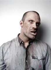 Fototapeta premium Male zombie looking away on white 