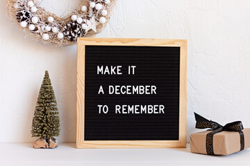 Felt letter board with text make it a december to remember and christmas decoration. Winter...