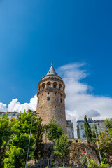 Fototapeta na wymiar Galata Tower in Istanbul in summer, symbolic landmark in Galata area of Istanbul, Turkey. The historical building is famous for tourists
