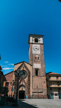 Vertical shot of the medieval cathedral external view against a blue sky in Chivasso, Italy