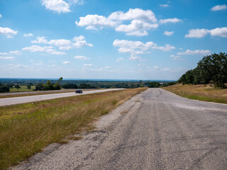 Roads Set Against a Cloud Studded Sky Lay Toward the Horizon 
