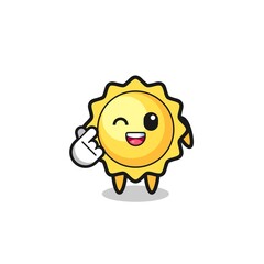 sun character doing Korean finger heart