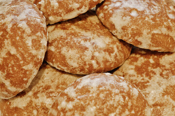 Close-up of russian round sweet gingerbread cookies with white sugar icing Delicious gingerbread for tea. Food background.
