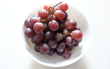 Grapes - Grapes in a bowl on a white background. Ripe grapes ready to eat