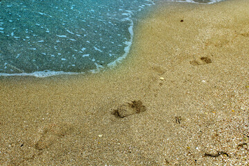 Blue sea wave on a pebble beach.
