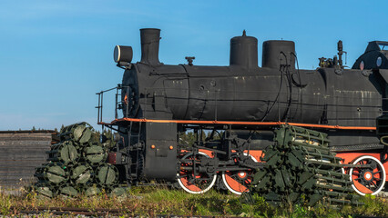 Retro Soviet steam locomotive. Veteran railways. Vintage black steam locomotive train rush railway.