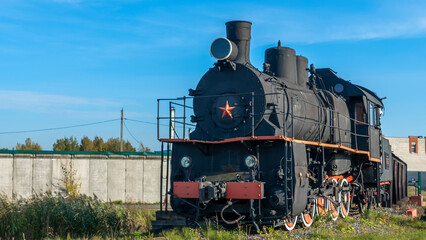 Retro Soviet steam locomotive. Veteran railways. Vintage black steam locomotive train rush railway.