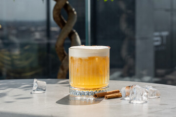 Apple cider cocktail with cinnamon and apple slices traditional autumn and winter drink isolated on bright background.