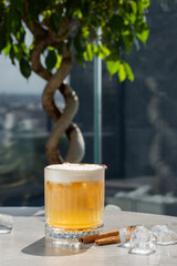 Apple cider cocktail with cinnamon and apple slices traditional autumn and winter drink isolated on bright background.