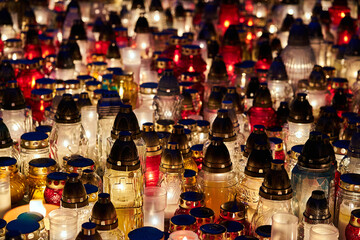 fires burning on a grave in the cemetery of All Saints' Day