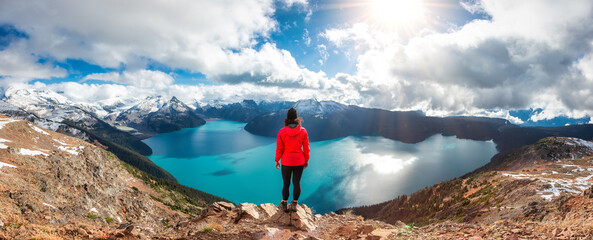 Adventurous Caucasian Woman hiking on top of a Canadian mountain. Taken on Panorama Ridge,...
