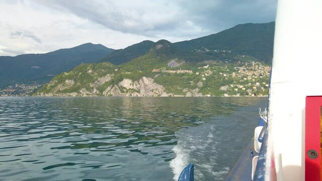 Short clip shot from a boat, sailing on Lake Como, from Varenna to Menaggio. It is a little overcast, but beautiful summer day. 4K