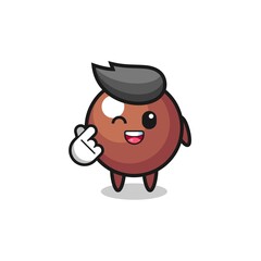 Obraz premium chocolate ball character doing Korean finger heart