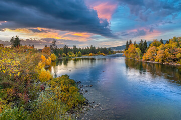 Colorful storm clouds above the Spokane River near the Barker Trail Head during Autumn, with fall...