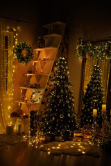 New Year 2021 interior with candles, bulbs and bokeh. Room decorated to christmas celebration. Christmas tree with presents
