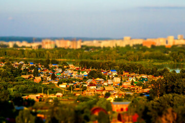 at sunset, an area with individual houses, far beyond the river, a block of multi-storey...