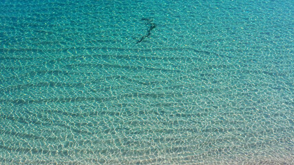 Aerial view of the ocean surface with clear water