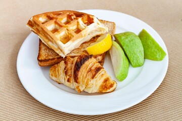 Western breakfast set plate, croissant, toast and fresh fruit
