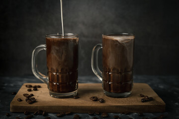 Fototapeta na wymiar Iced coffee and milk on dark table