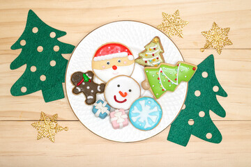 Christmas theme sugar coated cookies on a white plate.