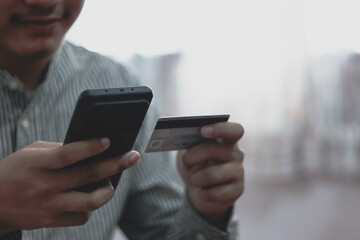 Close up man purchusing or paying domestic bills online by credit card, using laptop, young man customer making secure internet payment.