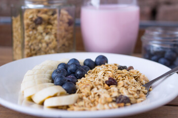 plate with muesli, blueberries and banana - closeup