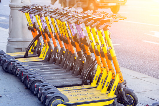 Moscow, Russia - October 14, 2021:  Street parking with electric multi-colored electric scooters Yandex go, Whoosh, Urent under the bright sun