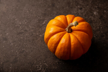 Small orange pumpkin close up. Pumpkins are widely grown for commercial use and as food,...