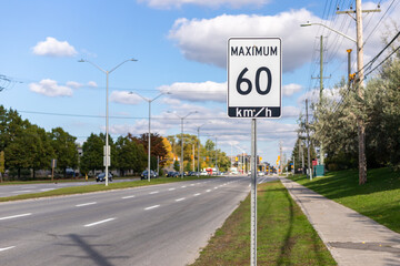 Speed limit road sign in the street, 60 km per hour maximum in Ottawa city, Canada. City traffic on the road. - obrazy, fototapety, plakaty