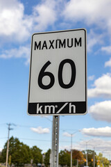 Speed limit road sign in the street, driving 60 km maximum in Ottawa, Canada. Traffic on the road