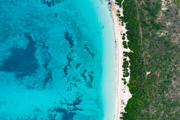 View from above, stunning aerial view of a white sand beach bathed by a turquoise water. Capo Coda Cavallo, Sardinia, Italy.
