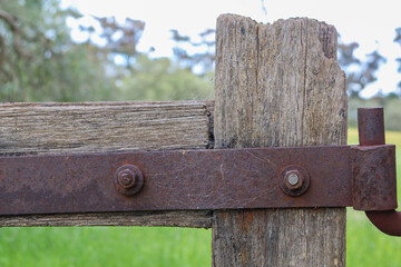 old wooden gate with rusted hinge