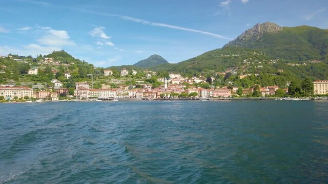 Short clip shot from a boat, sailing on Lake Como, from Varenna to Menaggio. It is a little overcast, but beautiful summer day. 4K