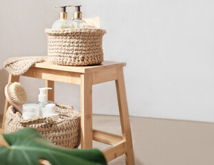 Fototapeta na wymiar knit jute baskets with toiletries on light wooden A stand in a room. natural eco interior design, boho or country style.copy space.
