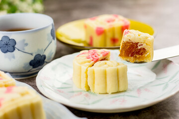 Close up, Homemade bakery concept. Delicious cutting pineapple cookies look like mooncake on white plate with copy space.