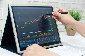 A business examines the financial graph of sales growth on the computer