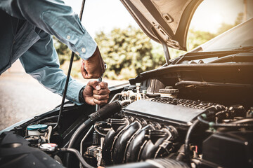 Car care maintenance and servicing, Close-up hand technician auto mechanic using the wrench to repairing change spare part car engine problem. Concepts of check and during periodic inspection service.