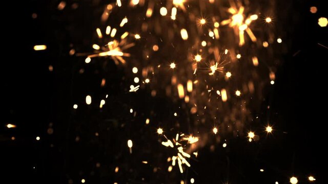 Bright sparks of New Year's fireworks on a black background. High quality FullHD footage. Filmed is slow motion 1000 fps.