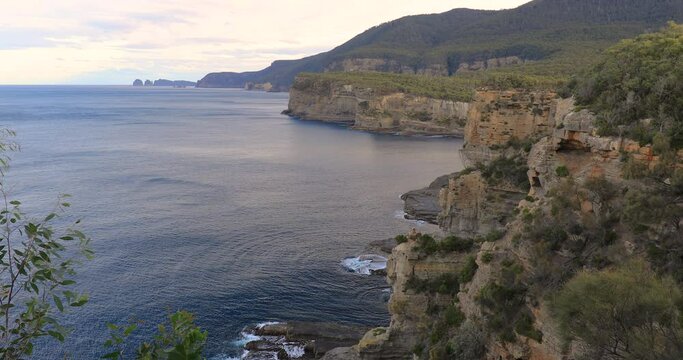 Locked Off Motion Of Cliff Edge At Tasmans Arch Near Eaglehawk Neck With Tasman National Park In Background, Tasmania, Australia