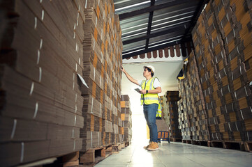 Warehouse workers checking stock in a large warehouse in a large warehouse.