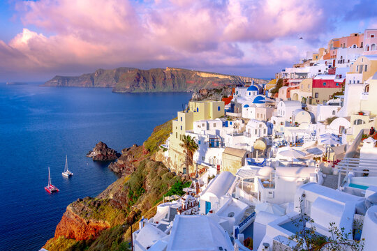Oia town on Santorini island, Greece. Traditional and famous houses and churches with blue domes over the Caldera, Aegean sea © gatsi