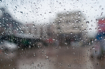 Rainy day background with copy space. Drops of water on car glass.Entering the rainy season.