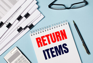 On a light blue background there are documents, glasses, a calculator, a pen and a notebook with...