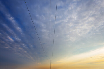 electric post and wire on dramatic sky background, concept industry background