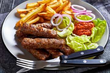 cevapcici with potato fries, lettuce, onion, ajvar